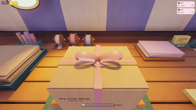 A closed parcel with a pink ribbon bow on the packing table